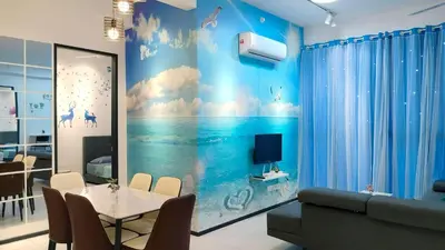 a living room with a table and a blue wall at Ocean Home@Urban Suites@12 Pax in Jelutong