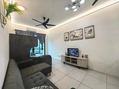 a living room with a couch and a tv at Summer Cozy Big Studio in Perai