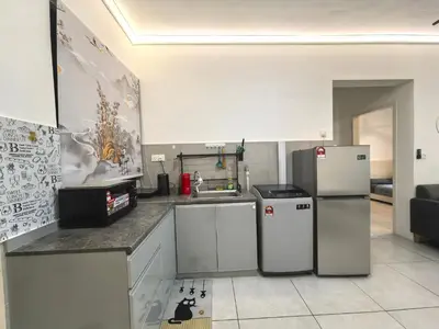 a kitchen with a refrigerator and a sink at Summer Cozy Big Studio in Perai