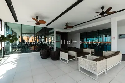 a lobby with tables and chairs and ceiling fans at Summer Cozy Big Studio in Perai