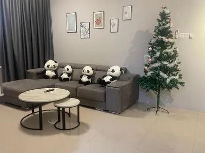 a living room with a christmas tree and stuffed panda bears on a couch at IPOH TAMBUN THE COVE Your Ultimate Relaxation Getaway777 -3 BED ROOM -NO PETS ALLOW in Ipoh