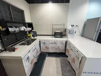 a kitchen with white counter tops and a sink at JZ at Sungai Besar Single Storey Semi-D in Sungai Besar
