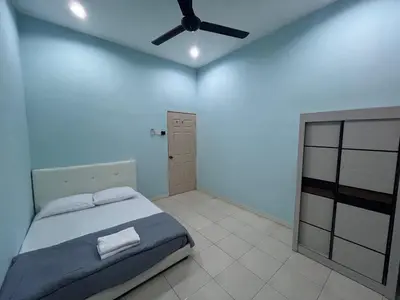 a bedroom with a bed and a ceiling fan at JZ at Sungai Besar Single Storey Semi-D in Sungai Besar