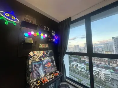 a room with a video game in front of a window at 3 Room/3 Queen Bed, Urban Suite Arcade Room #2carpark in Jelutong