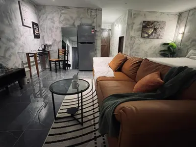 a living room with a couch and a table at The Ash Ipoh - Family Suite in Ipoh