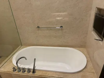 a bath tub with a faucet in a bathroom at Perfect Marina @ Strait Quay /w Exclusive Stay in Tanjong Tokong