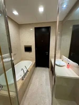 a bathroom with a tub and a sink and a black door at Perfect Marina @ Strait Quay /w Exclusive Stay in Tanjong Tokong
