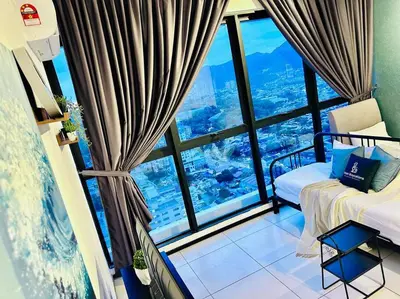 a room with a bed and a large window at New URBAN SUITES Seaview Family Homestay by Urban Staycation HENG LOD COSY in Jelutong
