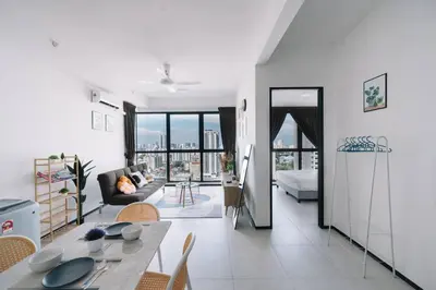 a living room with a table and a couch at NEW Infinity Pool Seaview Urban Suite #2Carparks #2BR 23a5 in Jelutong