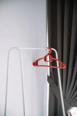 a red curtain hanger is attached to a window at NEW Infinity Pool Seaview Urban Suite #2Carparks #2BR 23a5 in Jelutong