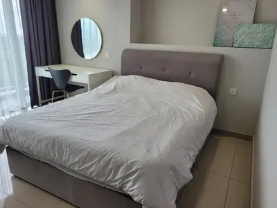 a bed in a bedroom with a desk and a mirror at Venus Cozy Home in Seri Manjung