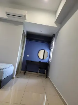 a small room with a bed and a mirror at Venus Cozy Home in Seri Manjung
