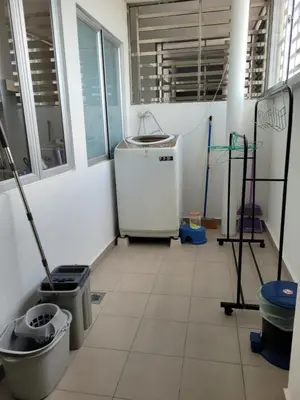 a kitchen with a refrigerator and a tiled floor at Venus Cozy Home in Seri Manjung