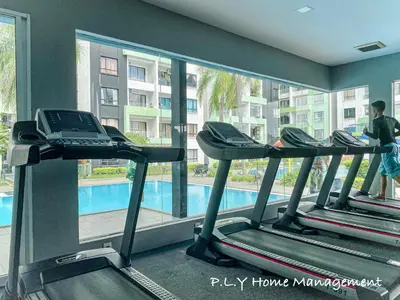 a gym with three treadmills and a swimming pool at Crystal Cozy Suite PoolView Netflix Waterpark@ Ipoh Station 18 in Ipoh