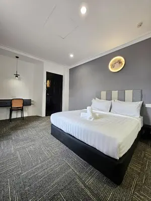 a bedroom with a large white bed and a desk at Luna Hotel by Moonknight in George Town