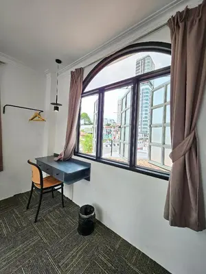 a room with a desk and a large window at Luna Hotel by Moonknight in George Town