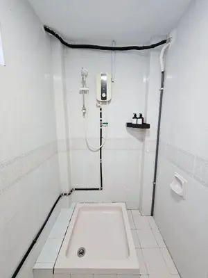 a white bathroom with a bath tub in it at Luna Hotel by Moonknight in George Town