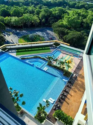 an overhead view of two pools at a resort at Home Cinema - BM City Centre - 4km to Icon City at The Metropol Muji Style Apartment in Bukit Mertajam