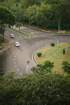 a curvy road with cars driving down it at Home Cinema - BM City Centre - 4km to Icon City at The Metropol Muji Style Apartment in Bukit Mertajam