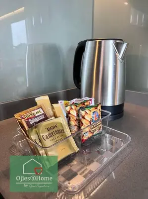 a tray of snacks on a counter next to a coffee pot at Ojieshome 1BR Sunway Onsen Tambun in Tambun