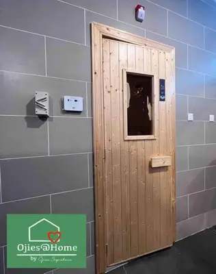 a wooden door in a room with a wall at Ojieshome 1BR Sunway Onsen Tambun in Tambun