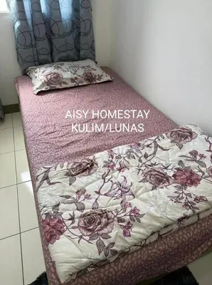 a bed with a sign that says ashley homestay kimlins at AISY HOMESTAY KULIM/LUNAS in Kulim