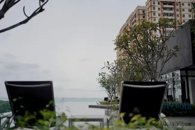two chairs sitting in front of a body of water at Urban Suites Homestay by Vista Vibes in Jelutong