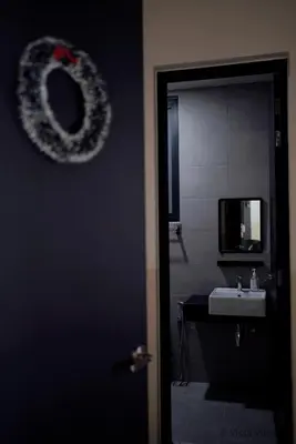 a bathroom with a sink and a door with a mirror at Urban Suites Homestay by Vista Vibes in Jelutong