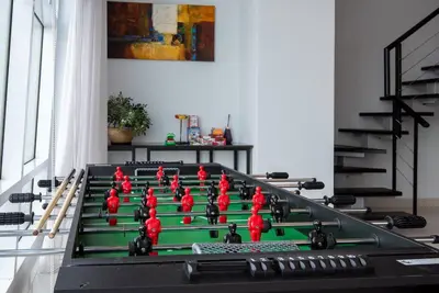 a green table with red figurines on top of it at Karaoke,XBox,Foosball,Billiard,Air Hockey,Ping Pong & Board Games in George Town