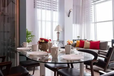 a dining room with a glass table and chairs at Karaoke,XBox,Foosball,Billiard,Air Hockey,Ping Pong & Board Games in George Town