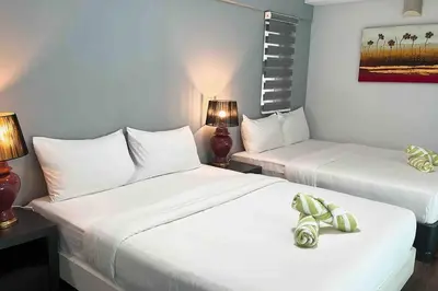 a hotel room with two beds and two lamps at Karaoke,XBox,Foosball,Billiard,Air Hockey,Ping Pong & Board Games in George Town