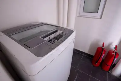 a microwave oven sitting on top of a refrigerator at XBox, Karaoke, Foosball, PoolTable, IceHockey, Ping Pong, Board Games in George Town