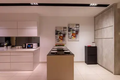 a kitchen with a stove top oven in a room at XBox, Karaoke, Foosball, PoolTable, IceHockey, Ping Pong, Board Games in George Town