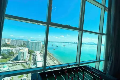 a view of the ocean from a window at XBox, Karaoke, Foosball, PoolTable, IceHockey, Ping Pong, Board Games in George Town