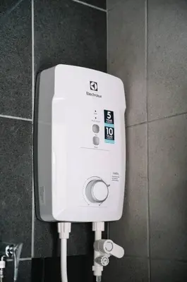 a white soap dispenser on a wall in a bathroom at NEW Infinity Pool Seaview 3Bedrooms 2Carparks 262 in Jelutong