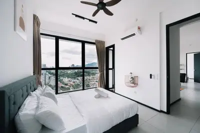 a bedroom with a bed and a large window at NEW Infinity Pool Seaview 3Bedrooms 2Carparks 262 in Jelutong