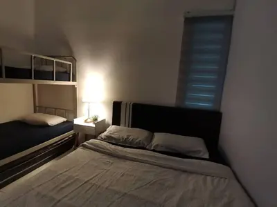 a small bedroom with a bed and a window at Muji Style brick themed Cameron Highland Homestay FREE Netflix in Tanah Rata
