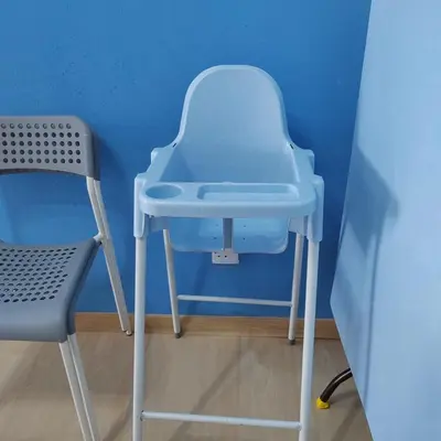 a blue stool and a chair in a room at Muji Style brick themed Cameron Highland Homestay FREE Netflix in Tanah Rata