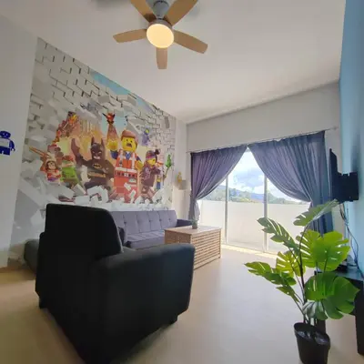 a living room with a couch and a ceiling fan at Muji Style brick themed Cameron Highland Homestay FREE Netflix in Tanah Rata