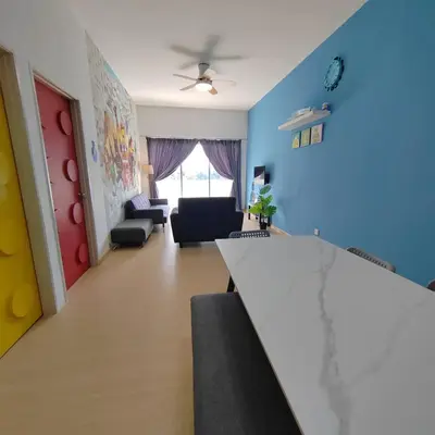 a living room with blue walls and a table at Muji Style brick themed Cameron Highland Homestay FREE Netflix in Tanah Rata
