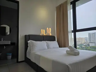a bedroom with a bed with two rabbits on it at Vanilla Cottage - Urban Suites by Ocean Luxe in Jelutong
