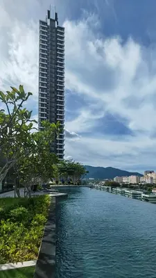 a river with a tall building in the background at Vanilla Cottage - Urban Suites by Ocean Luxe in Jelutong