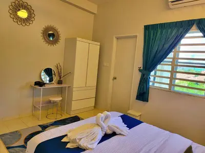 a bedroom with a bed with towels on it at Sunway Cozy Apartment near Lost World of Tambun in Ipoh