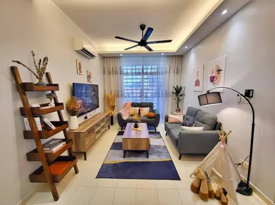 a living room with a couch and a table at Sunway Cozy Apartment near Lost World of Tambun in Ipoh