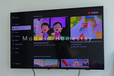 a television screen with a movie on it at Cozy&Comfy Suite Room Perai in Perai