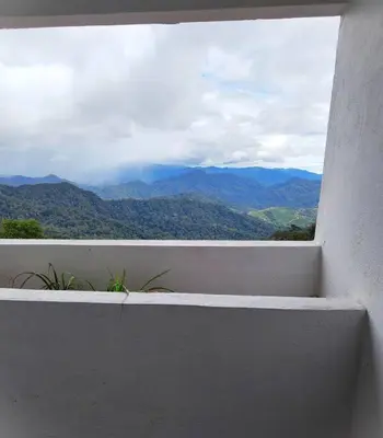a view of the mountains from a white balcony at Silverpart Resort Fraser Hill B5-6-1 Forest View High Floor No lift in Bukit Fraser