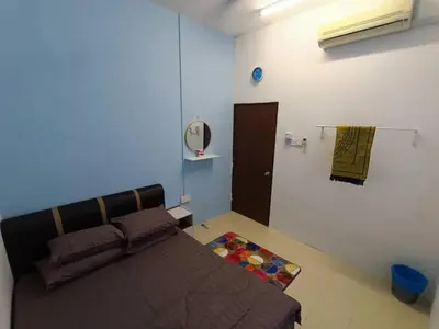 a bedroom with a bed and a mirror on the wall at Home MH Casa Damai Private Pool at Sungai Petani in Sungai Petani