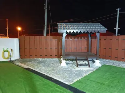 a gazebo with a bench in front of a fence at Home MH Casa Damai Private Pool at Sungai Petani in Sungai Petani