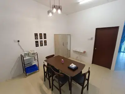 a dining room with a table and chairs in a room at Home MH Casa Damai Private Pool at Sungai Petani in Sungai Petani