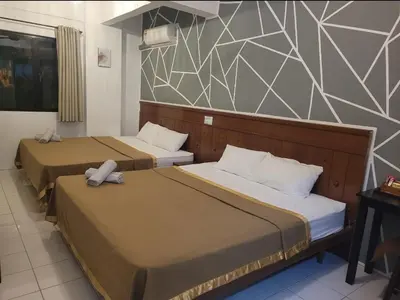 two beds in a hotel room with two bedsitures at Pangkor BeachWalk Studio in Pangkor